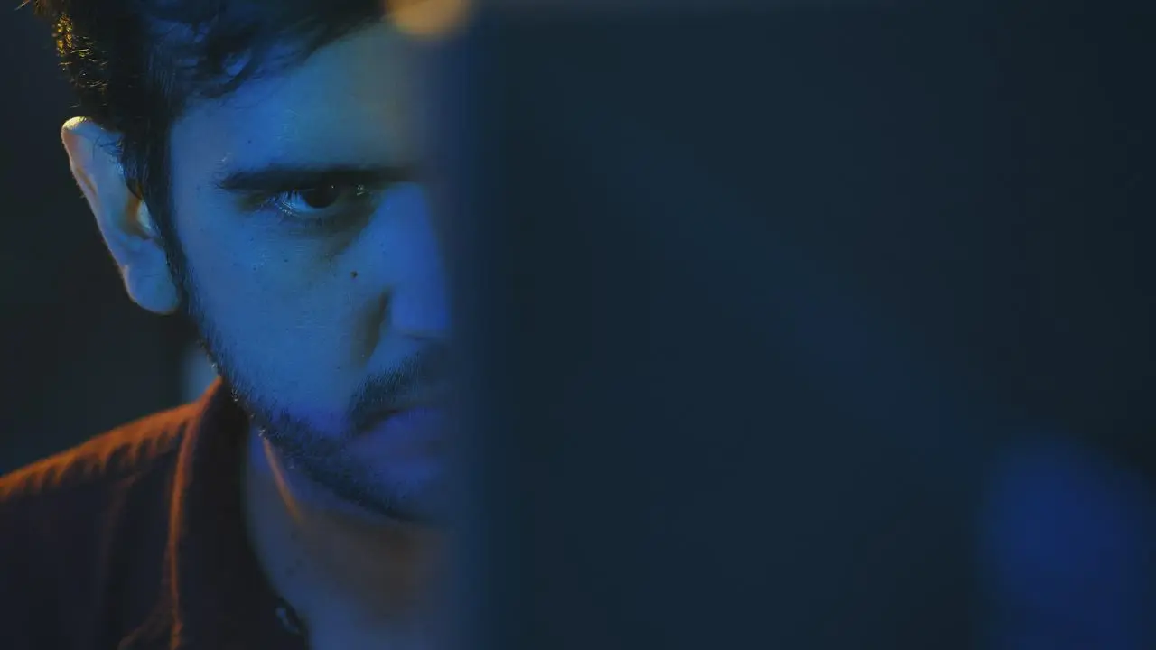A programmer focuses on the screen